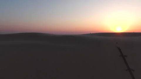 Lateral tracking close-up of Dune du Pilat with setting sun background, France Stock Footage 333108529