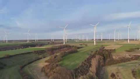 Lateral view across sprawling wind turbines and countryside Stock-Footage 331210909