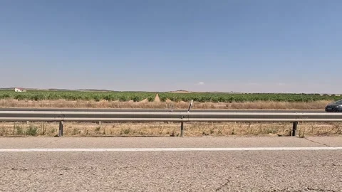 Lateral view of a highway surrounded by fields Video stock 342494339