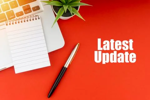 LATEST UPDATE text with notepad, laptop, fountain pen and decorative plant on Stock Photos
