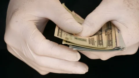  latex gloved hand counting US Dollar bills Stock-Footage 127253765