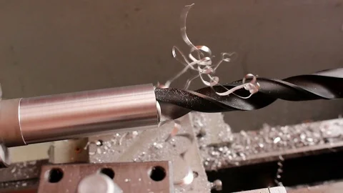 Lathe machine. Drilling a hole in a round timber. Metal shaving, chip. Stock Footage 102793856