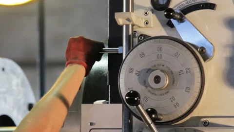 The lathe machine operator adjusts the machine. Machine operator in the factory Stock Footage 91265898