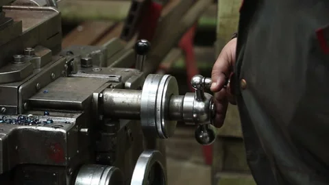 The lathe in operation is controlled by the hand of a working toolmaker Stock Footage 170714808