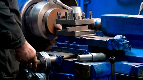 Lathe operator working on a metal piece. Stock Footage 341790089