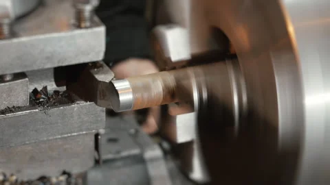 A lathe processes an iron workpiece in a workshop. Stock Footage 306541347