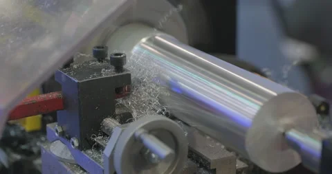 A lathe is working, the cutter is processing a cylindrical aluminum part Stock Footage 295788271