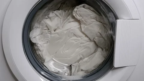 Lather from the detergent drips down the washing machine. Stock Footage 157555828