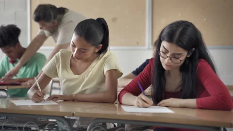 Latin and Hispanic Female Students writing exam in the college high school Stock Footage