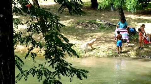Latin boy having fun bathing in a river and playing with his friends after trekk Vídeos de archivo 80453358