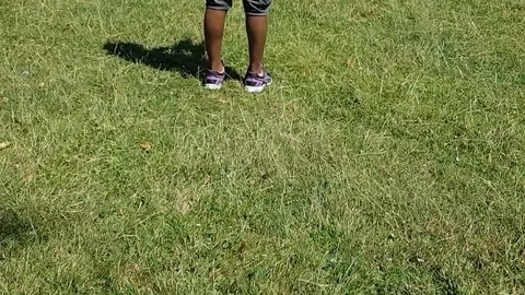 Latin boy operating a drone with remote control. Quadro copter drone flying over Vídeos de archivo 97938534