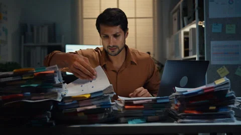 Latin businessman working late on document at office night. Stock Footage 340971126