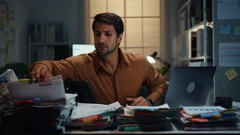 Latin businessman working late on document at office night. Stock Footage 340971149