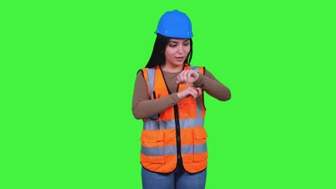 Latin construction worker woman checking time on greenscreen Stock Footage 308743338