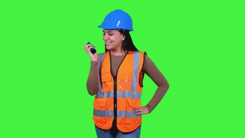 Latin construction worker woman talking on walkie-talkie on green screen Stock Footage 308743350