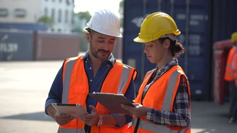 Latin containers worker man using digital tablet and harbor worker woman hold Stock Footage 156381326