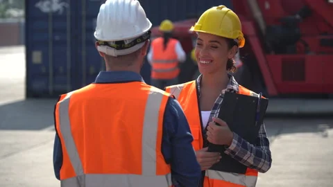 Latin containers worker using digital tablet and harbor worker woman holding Stock Footage
