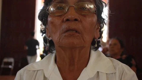 Latin elderly woman praying inside a church in Central America Stock Footage 87217088