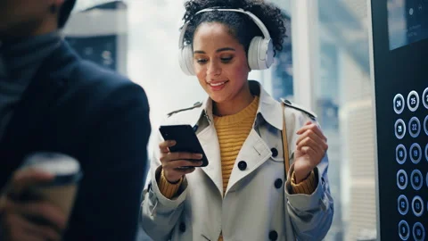 Latin Female Riding Elevator Using Smartphone Stock Footage 167554061