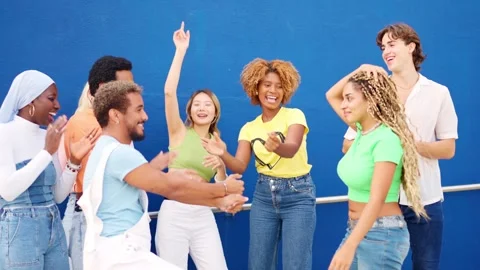 Latin friends dancing among multi-ethnic friends in an urban space Stock Footage 268761734