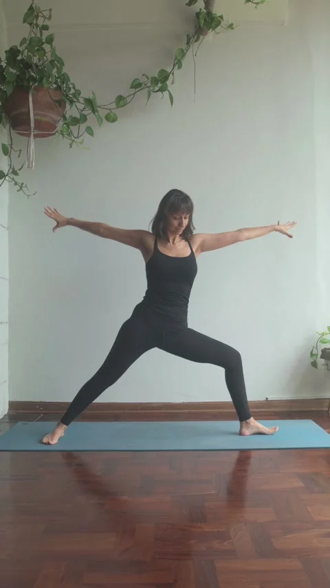 A latin girl practicing the side angle yoga posture in her studio. Concept .. Stock Footage 282486292