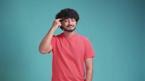 Latin hispanic man pointing his finger at his head showing high intellect and Stock Footage 239359888