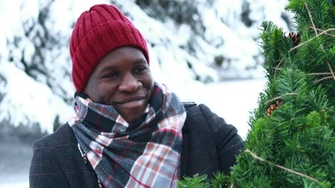 Latin hispanic man in red hat , scarf and stylish coat carrying eco reusable Stock Footage 221680744