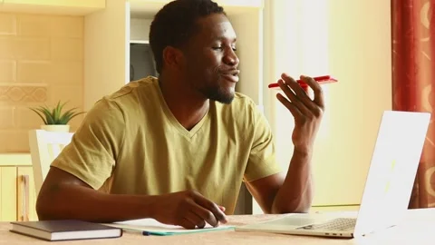 Latin hispanic man talking by phone near laptop and papers at kitchen Stock Footage 218985298