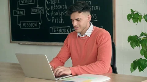 Latin Indian young programmer student sitting using laptop at modern office. Stock Footage 156967650