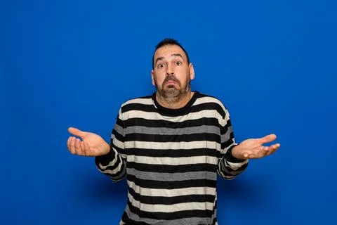 Latin man with beard doubt expression, concept of confusion and amazement, un Stock Photos