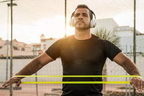 Latin man doing workout exercises session at sunset time 库存照片