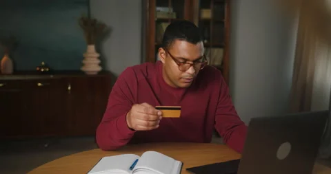 Latin man freelancer enters data from card being happy Stock Footage 228753673