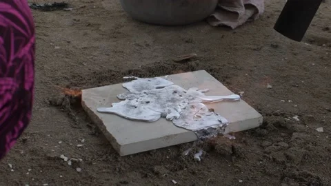 LATIN MAN HANDS CASTING LEAD CRAFTLY WITH FIRE AND HOME POT ON CERAMIC. Stock Footage 162312056