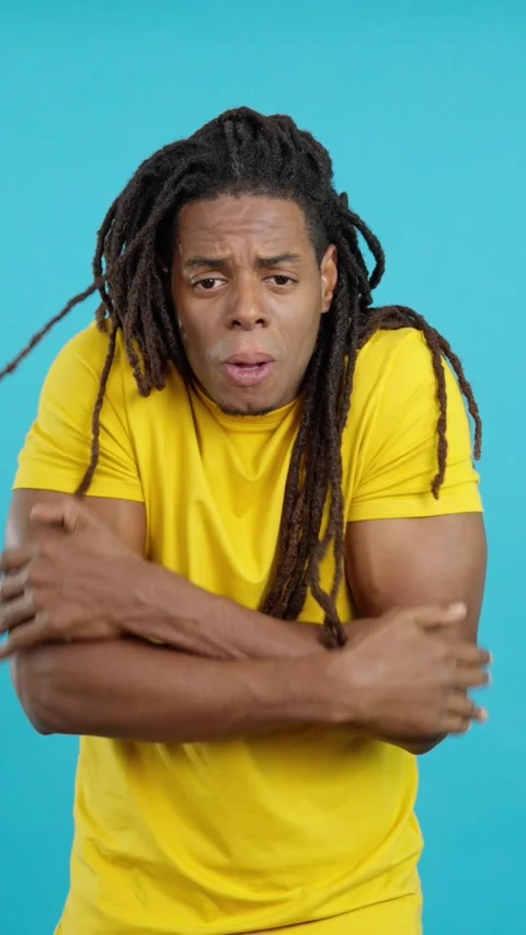 Latin man looking at camera gesturing he is cold 스톡 동영상 252484105