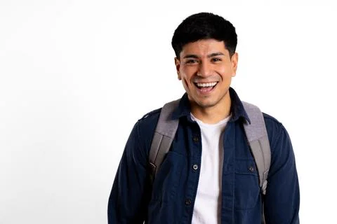 Latin man, looking at camera, laughing with backpack white background 库存照片