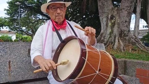 Latin man playing a drum Stock Footage 302740873