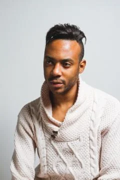 Latin man posing indoor over a grey wall. Stock Photos