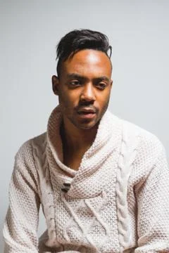 Latin man posing indoor over a grey wall. Stock Photos