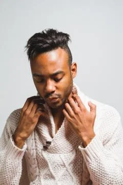 Latin man posing indoor over a grey wall. Stock Photos