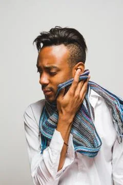 Latin man posing indoor over a grey wall. Stock Photos