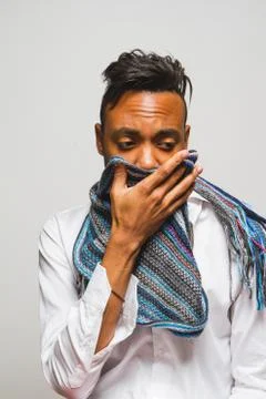 Latin man posing indoor over a grey wall. Stock Photos