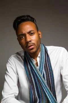 Latin man posing indoor over a grey wall. Stock Photos