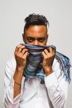 Latin man posing indoor over a grey wall. Stock Photos