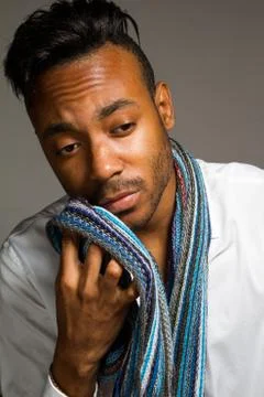 Latin man posing indoor over a grey wall. Stock Photos