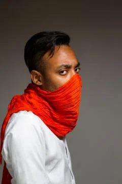 Latin man posing indoor over a grey wall. Stock Photos