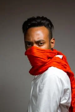 Latin man posing indoor over a grey wall. Stock Photos