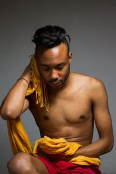 Latin man posing indoor over a grey wall. Stock Photos