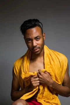 Latin man posing indoor over a grey wall. Stock Photos