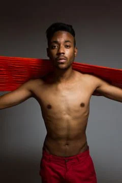 Latin man posing indoor over a grey wall. Stock Photos