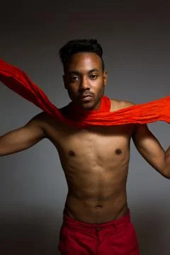 Latin man posing indoor over a grey wall. Stock Photos